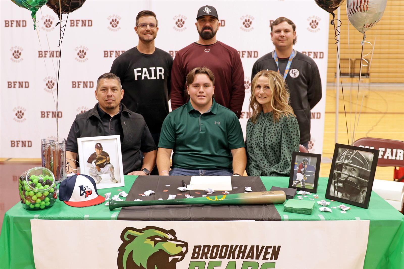 Cy-Fair senior Hunter Capunay, seated center, poses with his family and coaches after signing his letter of intent.